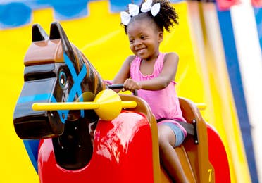 Small child riding mechanical horse at LEGOLAND Florida