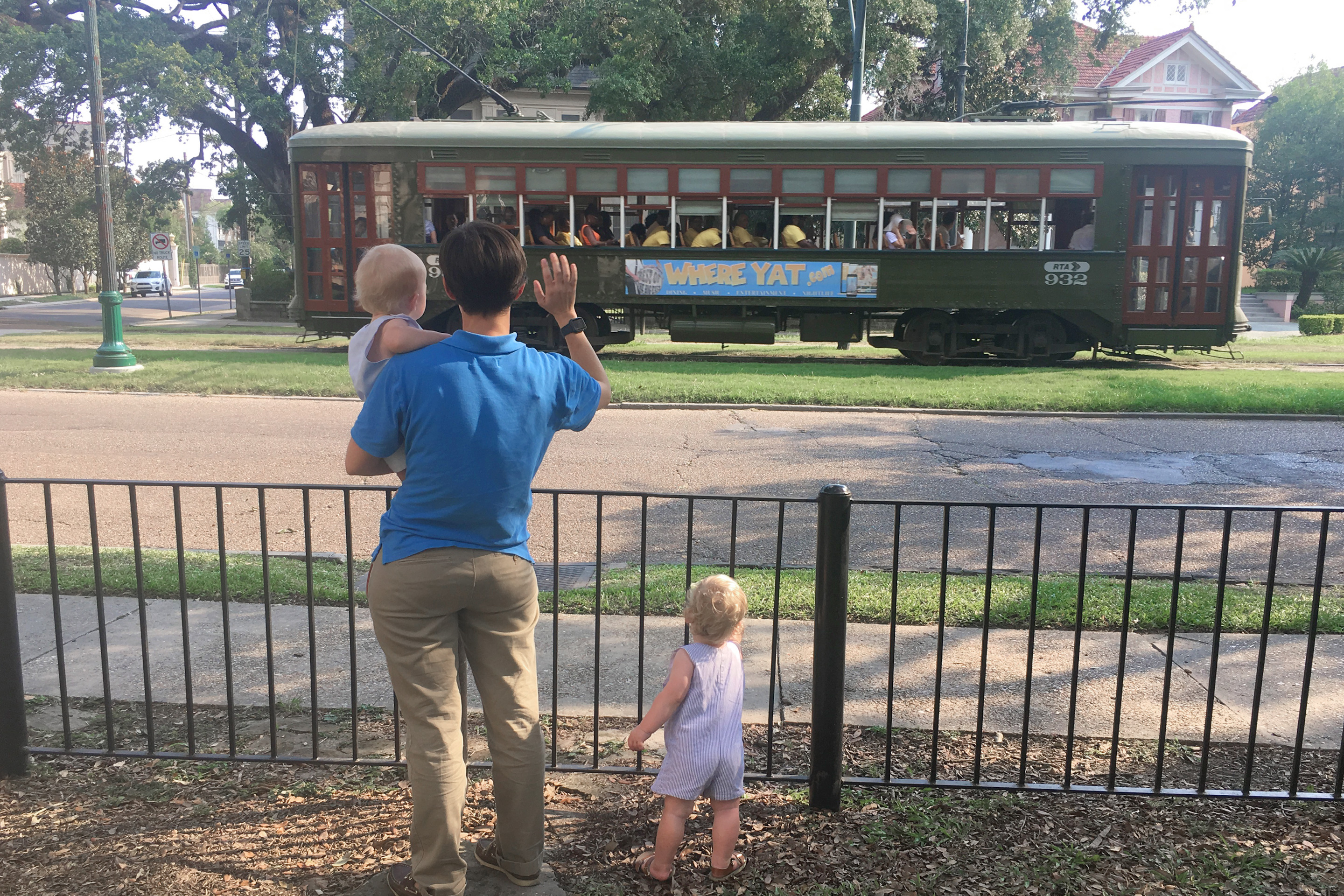 Featured Contributor, Catherine Karas' wife stands with her boys waving to the streetcar.