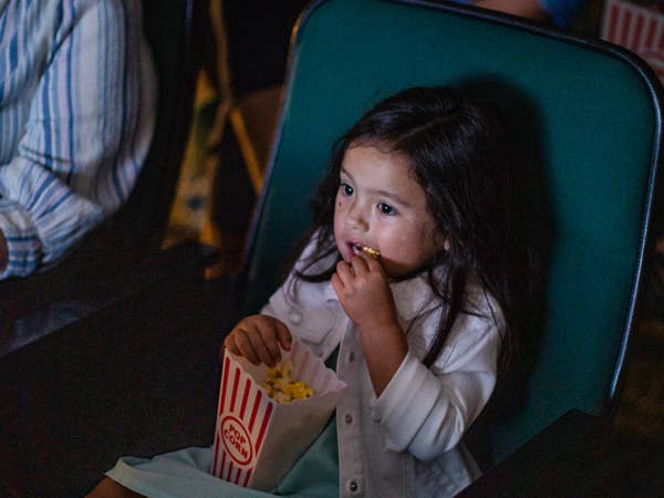 Movie theater, girl enjoying popcorn at Ozark Mountain Resort