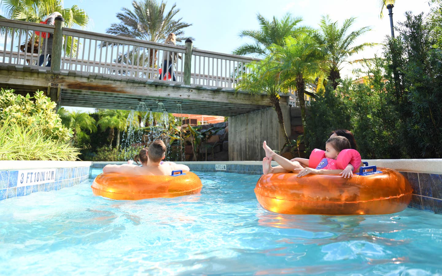 A family floating on inner tubes down a lazy river at Orange Lake Resort in Orlando, FL