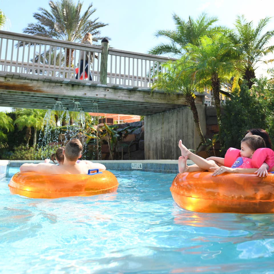 A family floating on inner tubes down a lazy river at Orange Lake Resort in Orlando, FL