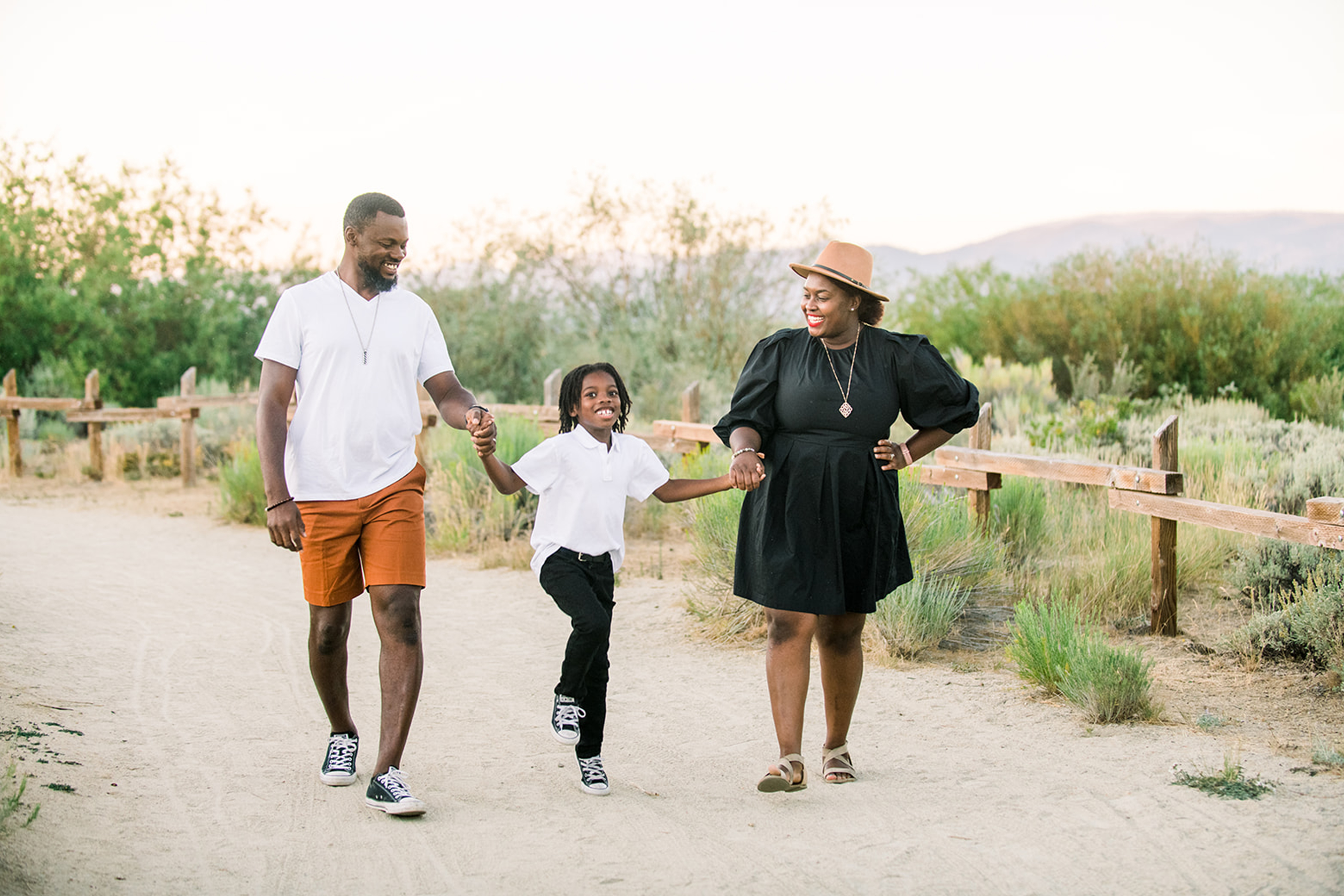 Karen and her family holding hands and walking down a path at Tahoe Keys Beach