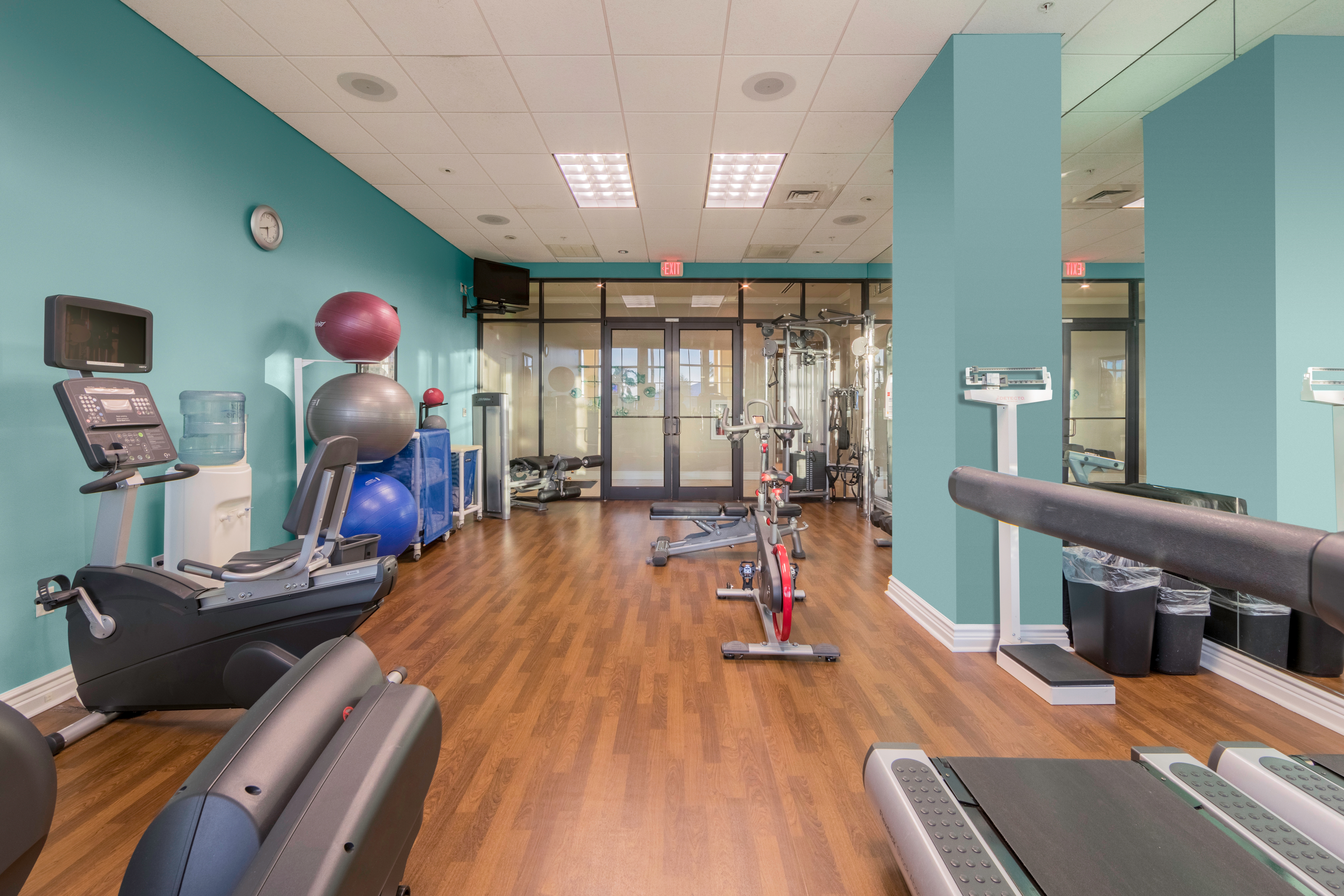 Fitness center with yoga balls, weights, and treadmills at Sunset Cove Resort in Marco Island, Florida.