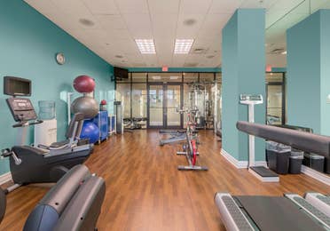 Fitness center with yoga balls, weights, and treadmills at Sunset Cove Resort in Marco Island, Florida.