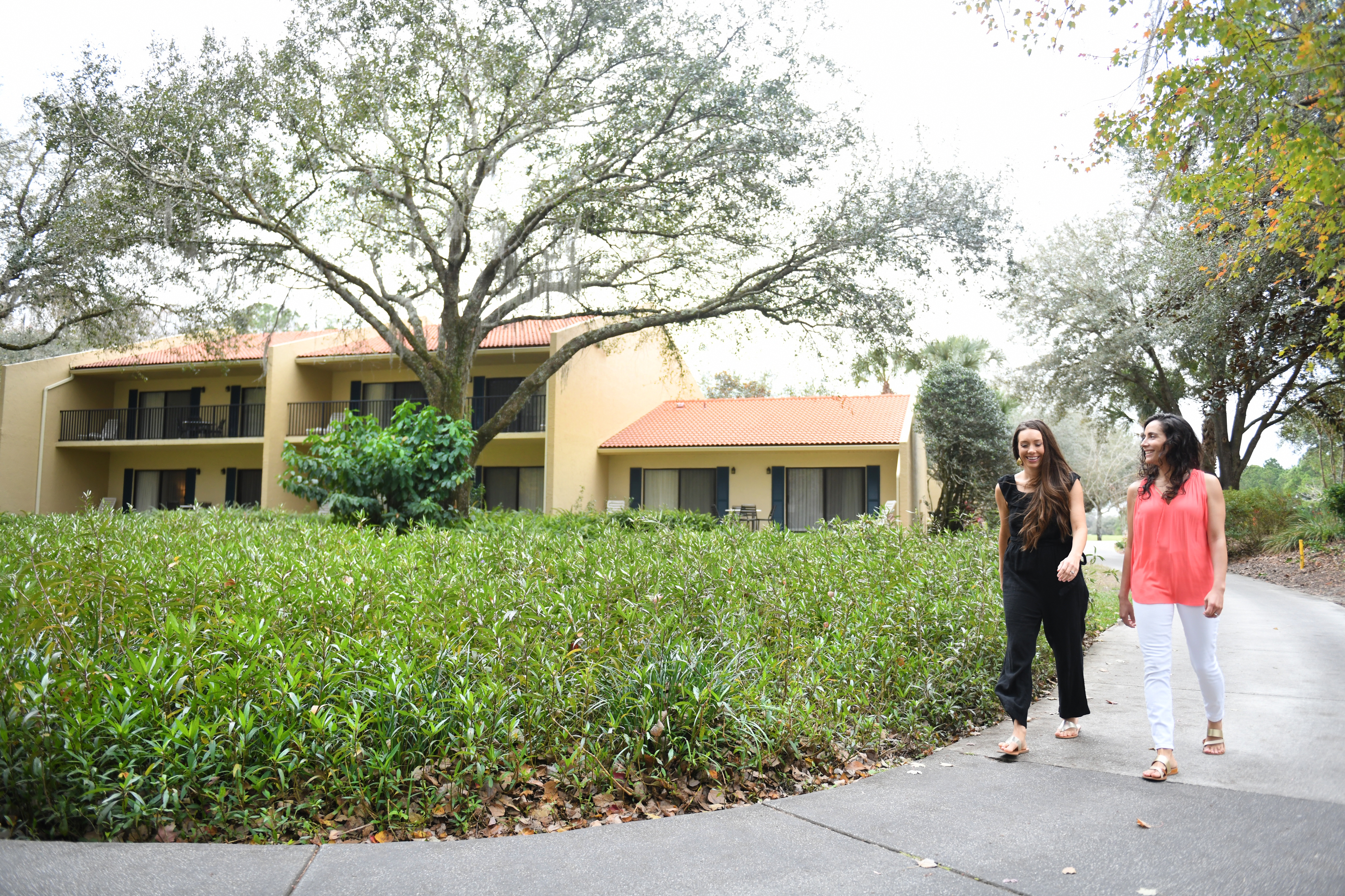 Two women walking around a resort property