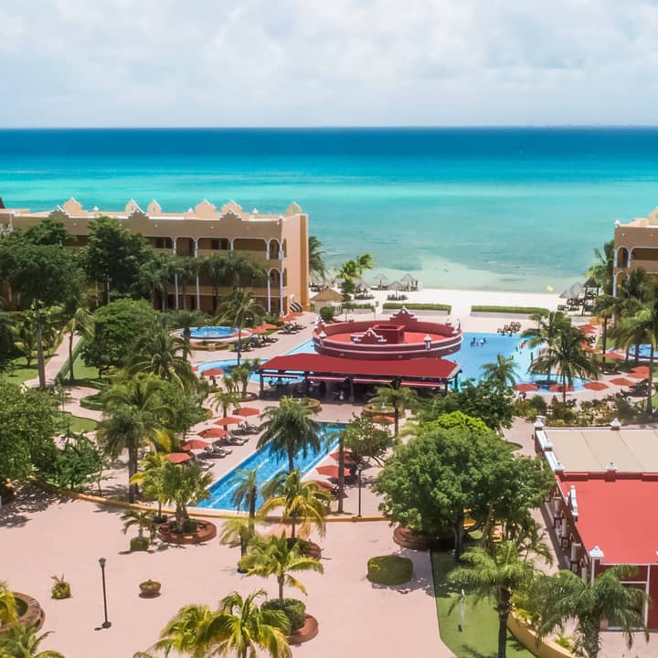 Aerial view of resort villas, outdoor pools and the ocean at The Royal Haciendas in Playa del Carmen, Mexico.