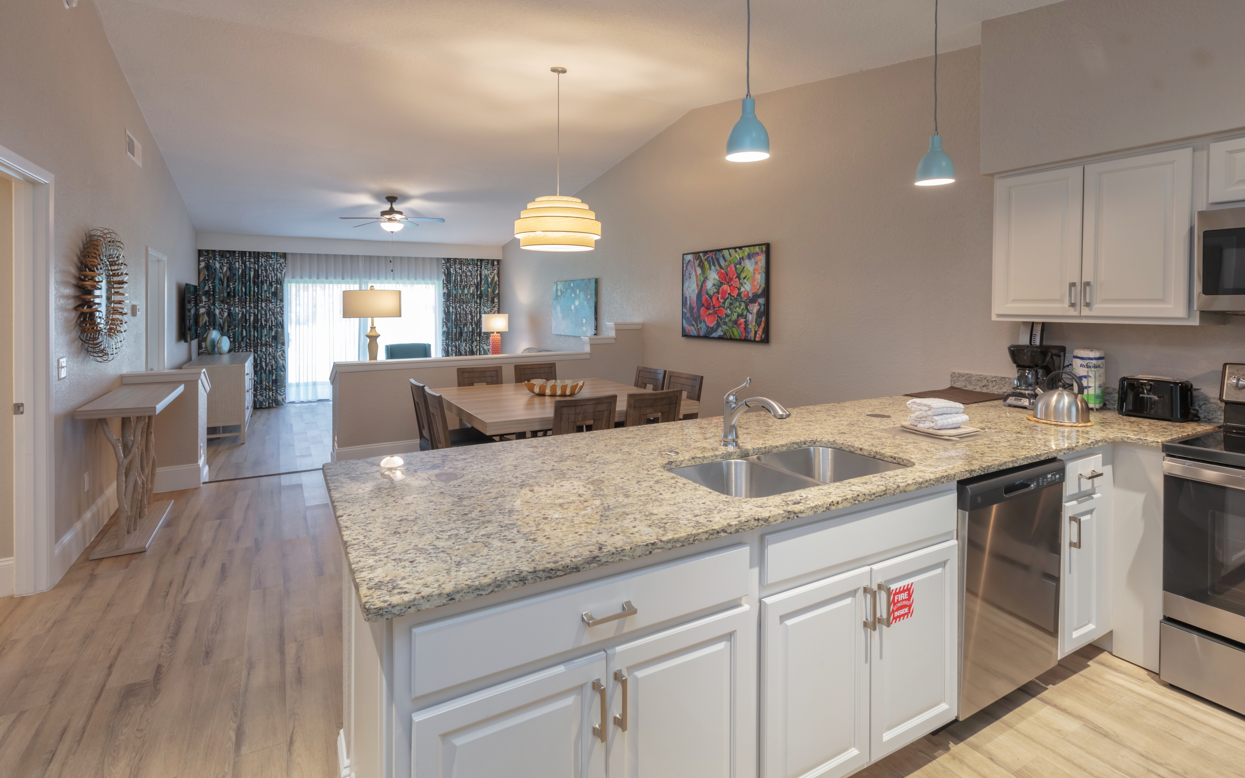 View of dining table and living room couch in a villa in West Village at Orange Lake Resort near Orlando, FL