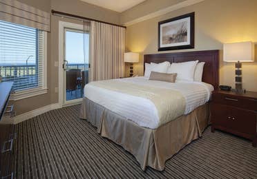 Master bedroom with access to furnished balcony in villa at Galveston Beach Resort