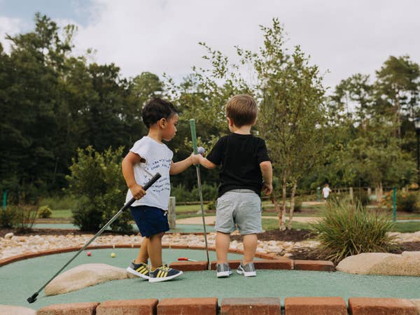 Two young children playing mini golf at Williamsburg Resort.