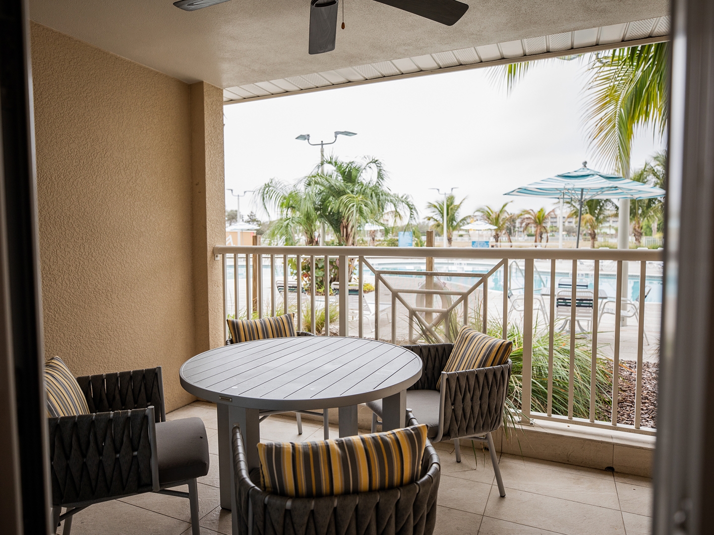 Balcony with pool view in a two-bedroom Signature Collection villa at Cape Canaveral Beach Resort.