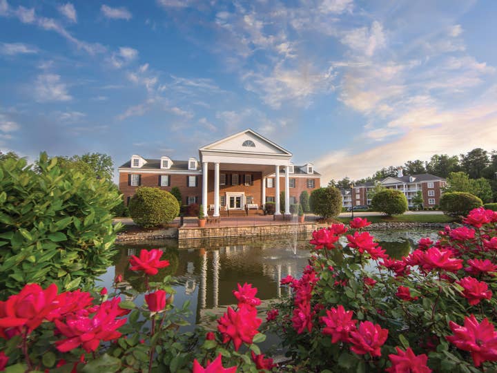 Property building surrounded by pink flowers at Williamsburg Resort in Virginia.