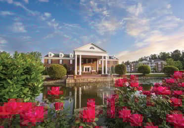 Property building surrounded by pink flowers at Williamsburg Resort in Virginia.