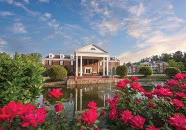 Property building surrounded by pink flowers at Williamsburg Resort in Virginia.