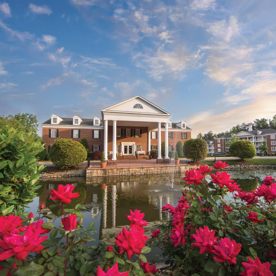 Property building surrounded by pink flowers at Williamsburg Resort in Virginia.