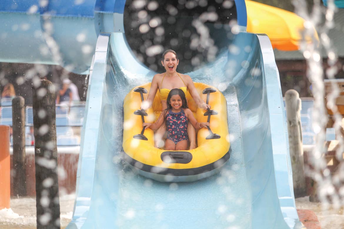 Woman and young girl coming down a waterslide at Schlitterbahn New Braunfels.