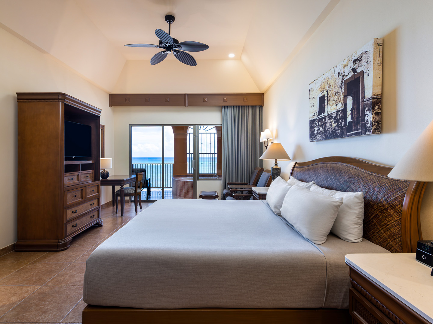 Beachfront master bedroom with a balcony and ocean views.