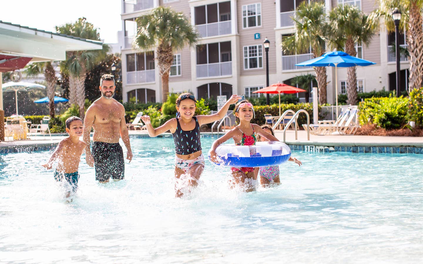 Family of four playing in pool at South Beach Resort in Myrtle Beach, South Carolina.