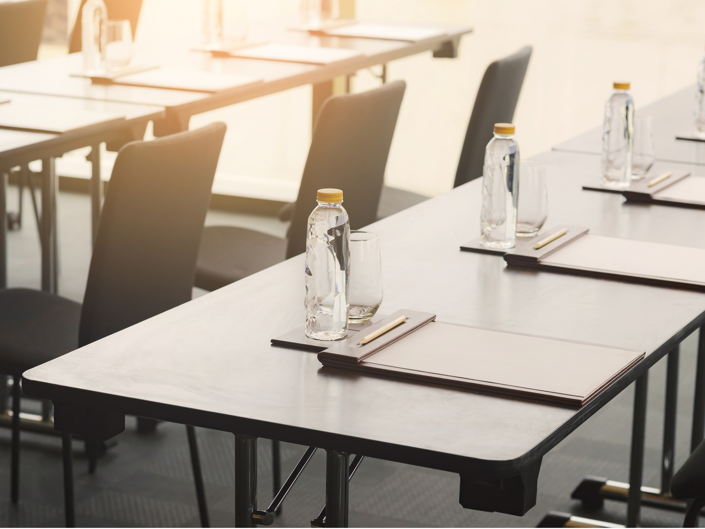 On-site meeting room with tables, chairs, water bottles and notepads at Banneker. 