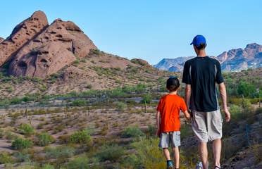 Jessica Averett's husband (right) and son (right) stand looking out at the McDowell Sonoran Preserve in Scottsdale, Arizona.