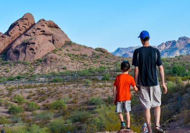 Jessica Averett's husband (right) and son (right) stand looking out at the McDowell Sonoran Preserve in Scottsdale, Arizona.