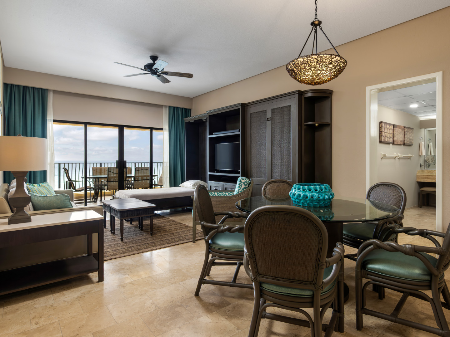 Oceanview living room with a Murphy bed, dining area, and balcony.