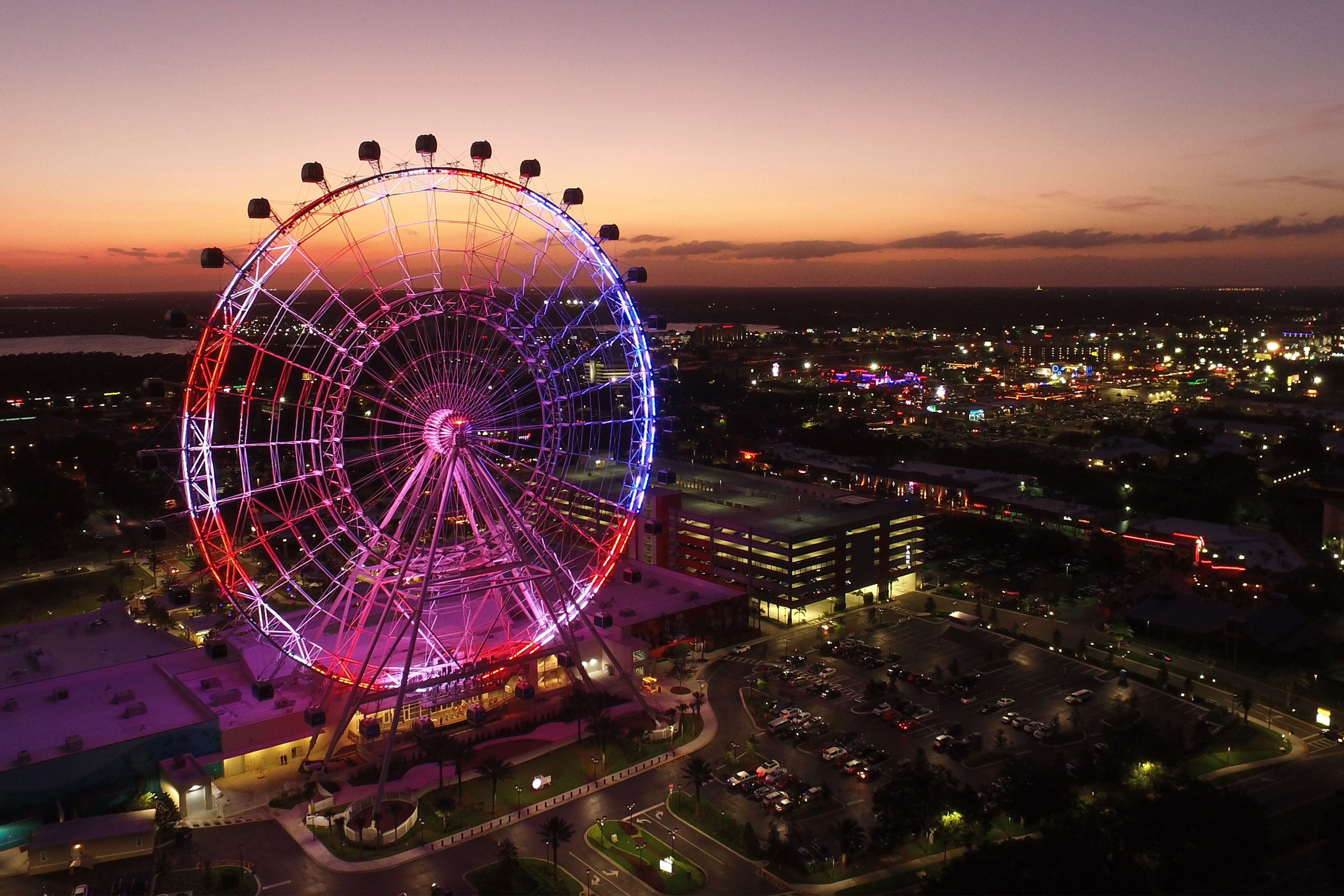 Aerial view of the Orlando Eye lit up at night.