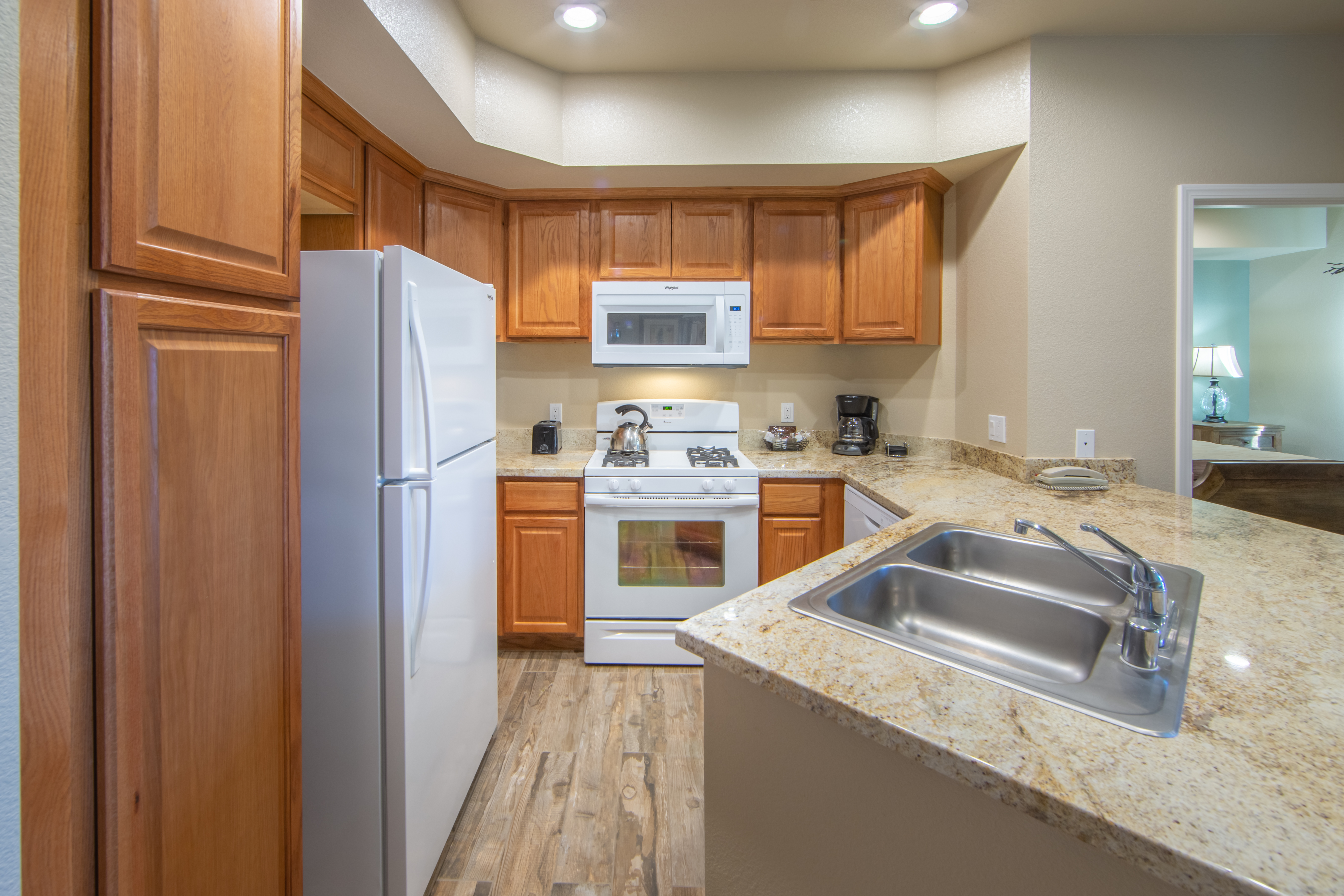 Kitchen with refrigerator, stove and microwave in an upgraded one-bedroom villa at David Walley's Resort in Genoa, Nevada