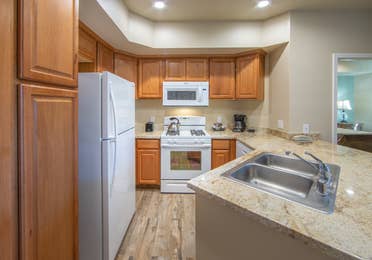 Kitchen with refrigerator, stove and microwave in an upgraded one-bedroom villa at David Walley's Resort in Genoa, Nevada