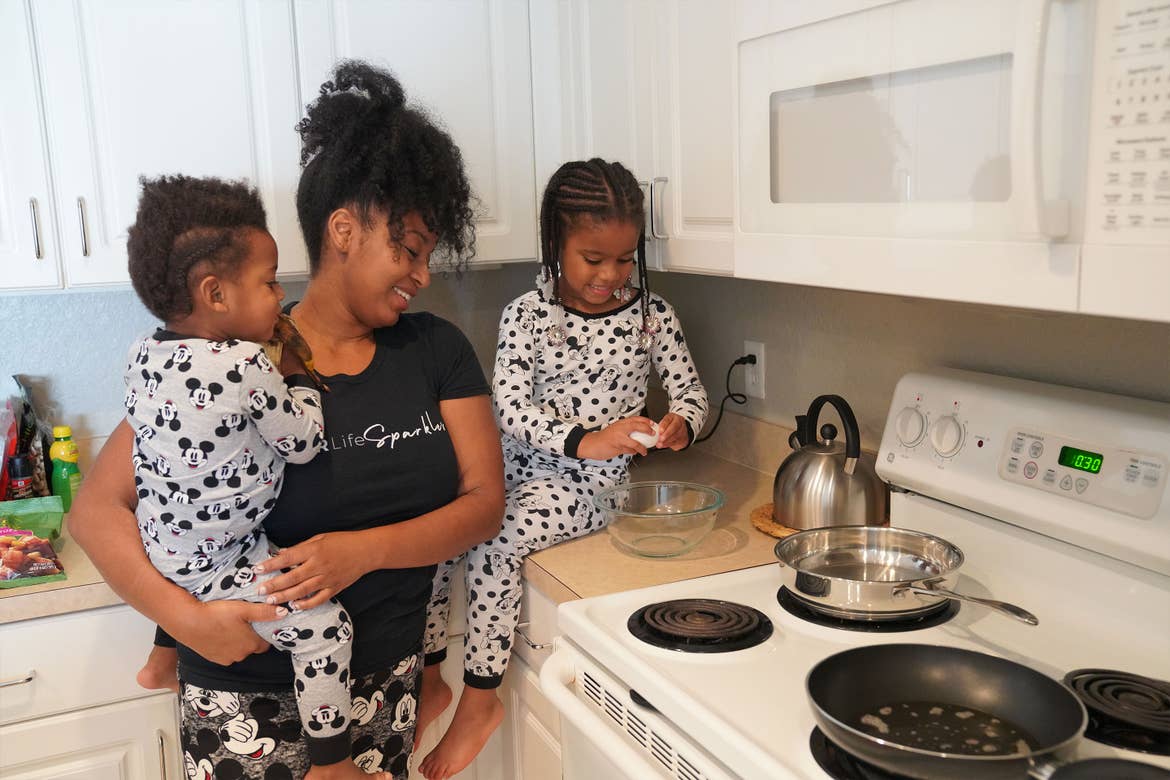 Featured Contributor, Tina Meeks, stands with her daughter and son making breakfast inside of their villa at our Orange Lake resort in Orlando, Florida.