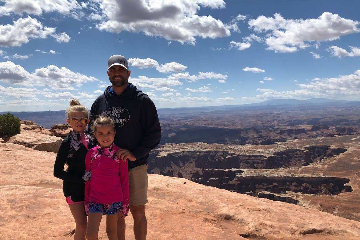 Josh (right) stands with Kyndall (left) and Kylar (middle) in front of the Grand View Hike overlook.