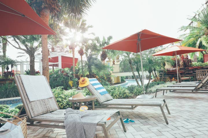 Sun chairs under umbrellas in River Island at Orange Lake Resort near Orlando, Florida.