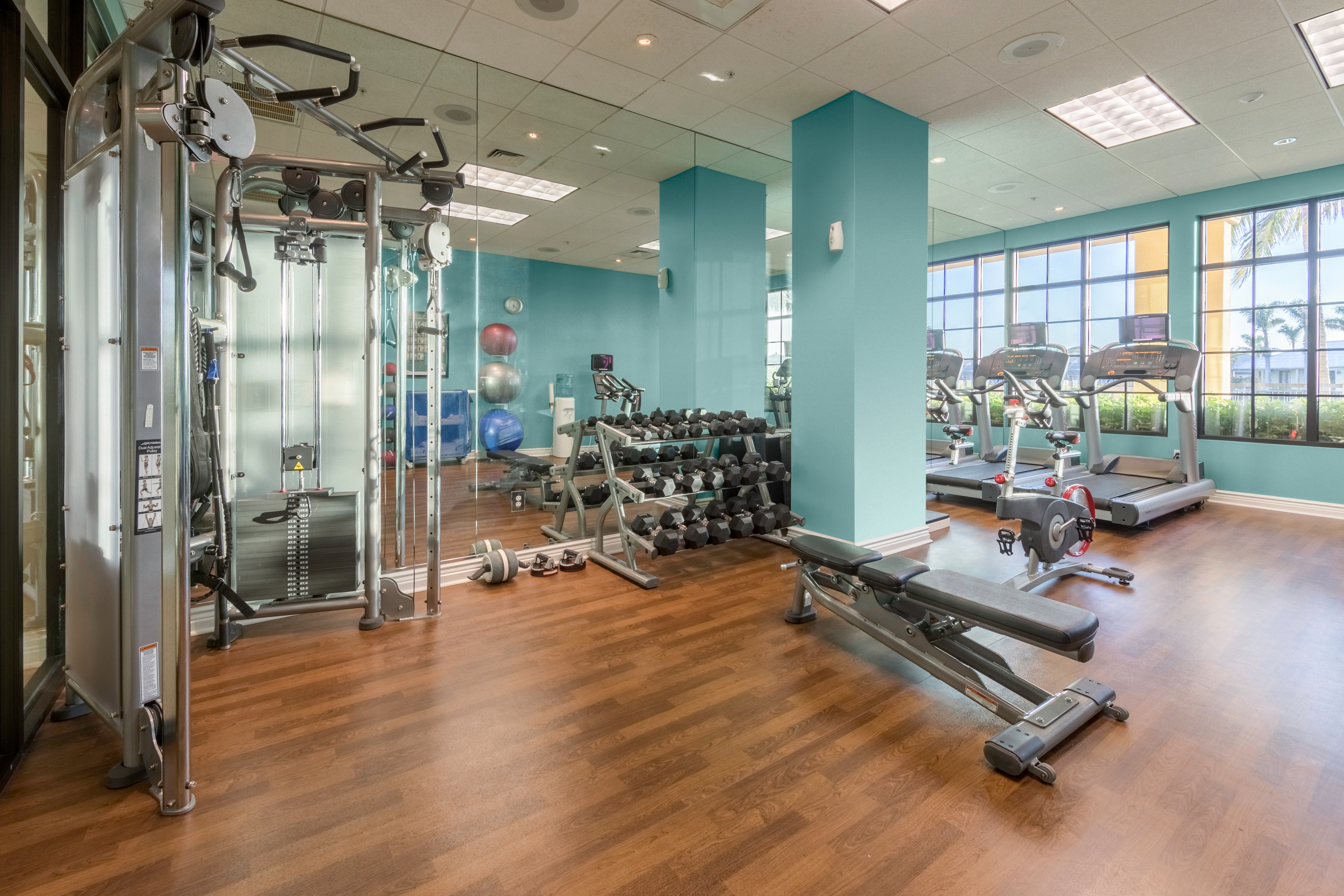 Fitness center with free weights and treadmills at Sunset Cove Resort in Marco Island, Florida.