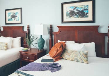 Close up of two beds with nightstand in between in a two bedroom villa in West Village at Orange Lake Resort near Orlando, FL