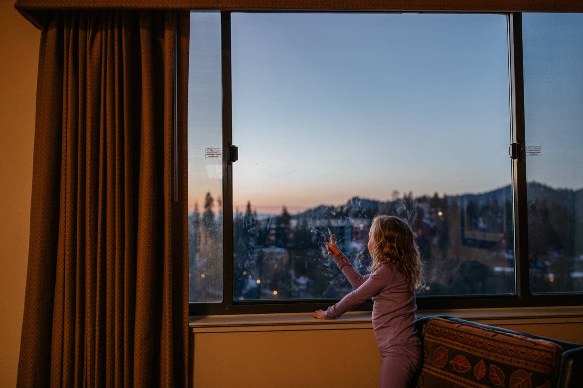 Andrea Rassmussen's daughter looks out their villa window to a starry night sky over the mountain range.