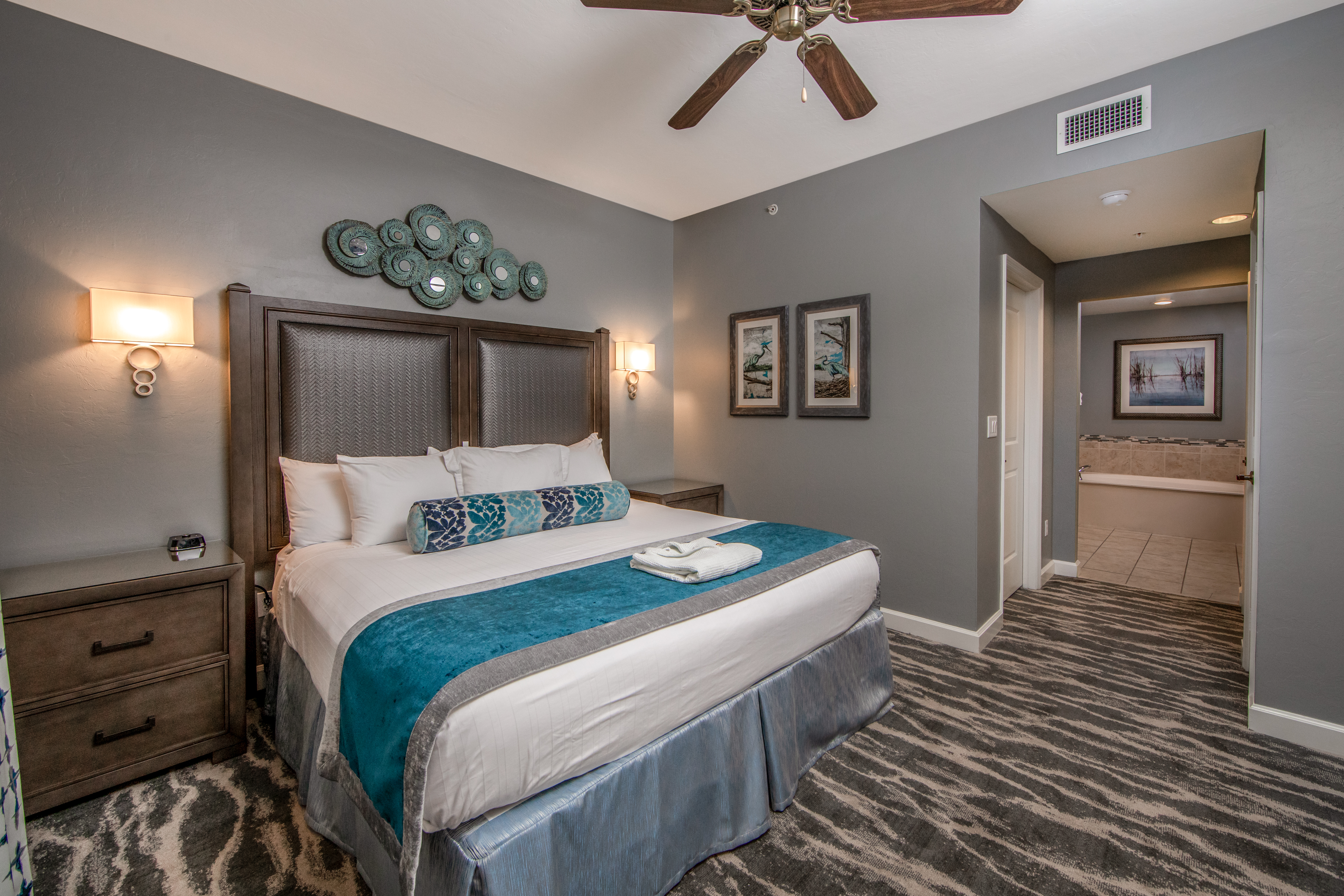 Bedroom with a king sized bed and attached bathroom in a three-bedroom villa at Sunset Cove Resort in Marco Island, Florida