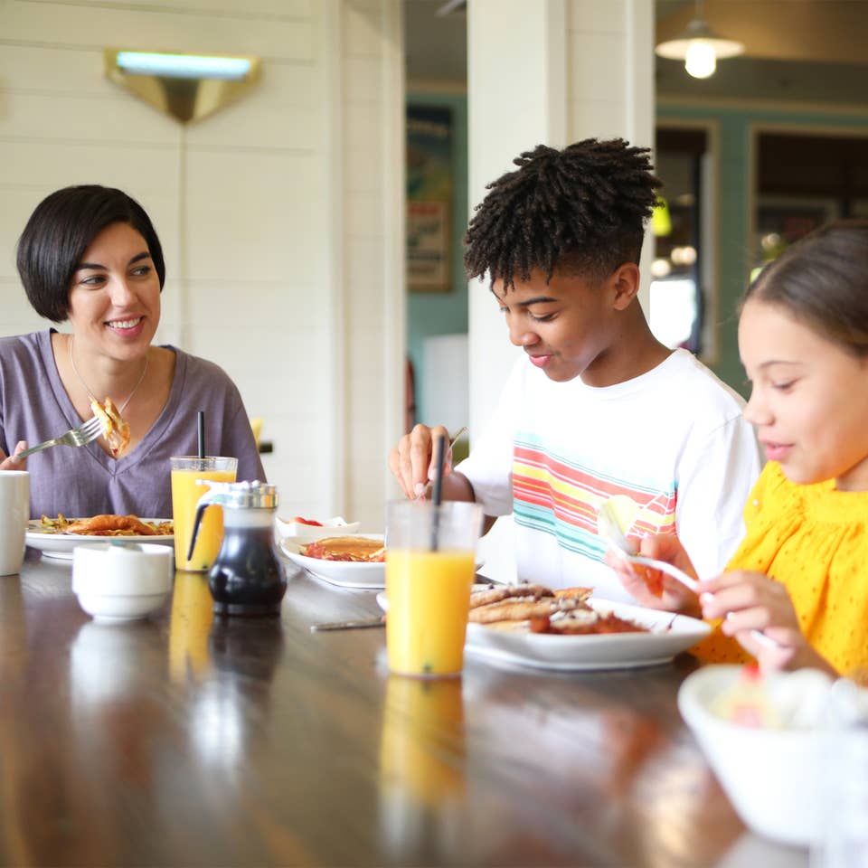 Family eating breakfast at Orange Lake Resort near Orlando, Florida.