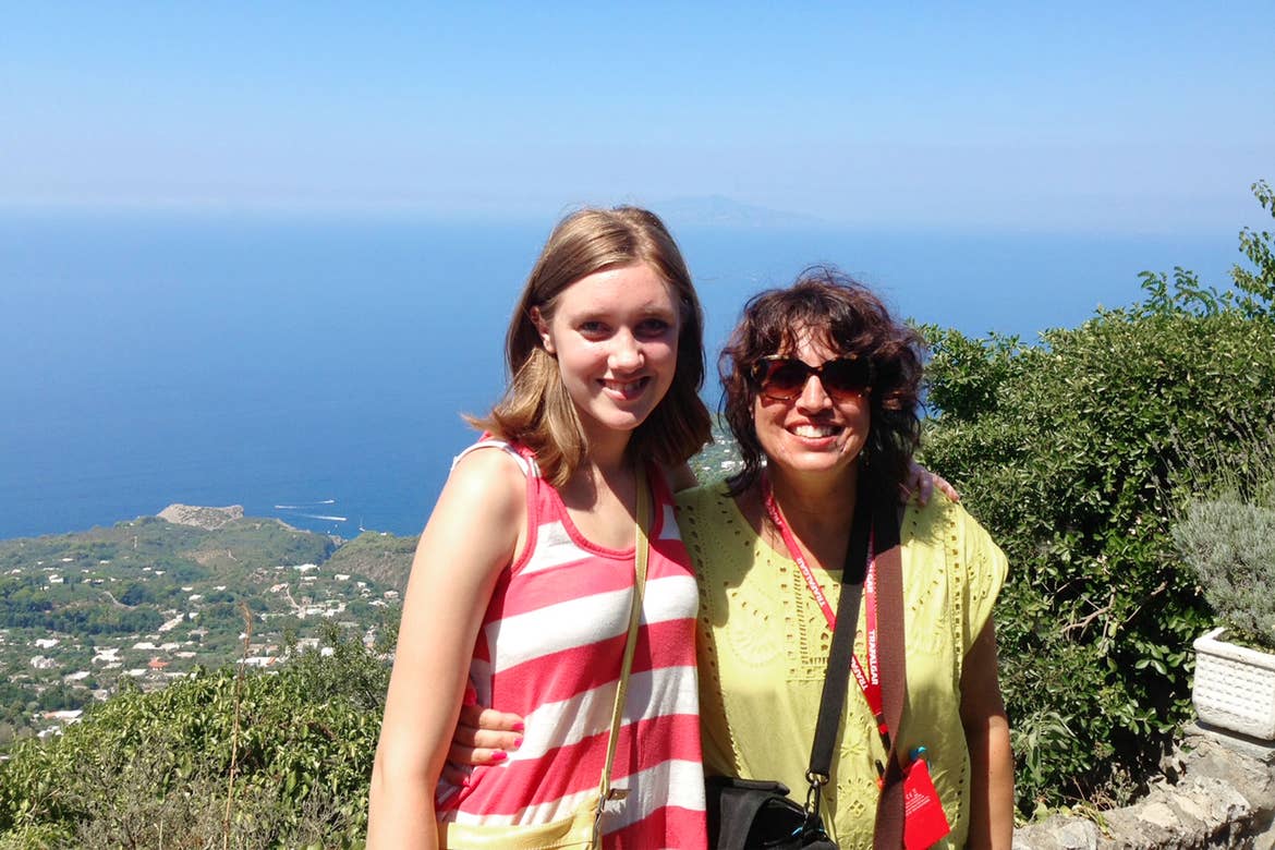 Featured Author, Jennifer Probst (right) stands with her niece (left) in front of a hill that overlooks the coastline of Italy.