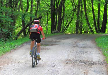 Image of a guy riding a mountain bicycle along the Fox River Bike Trail in Sheridan, Illinois.