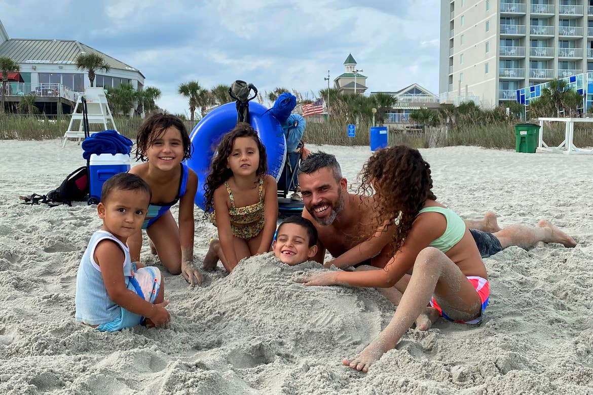 Author, Brenda Rivera Sterns' family plays in the sand on the beach in front of our South Beach Resort in Myrtle Beach, South Carolina.