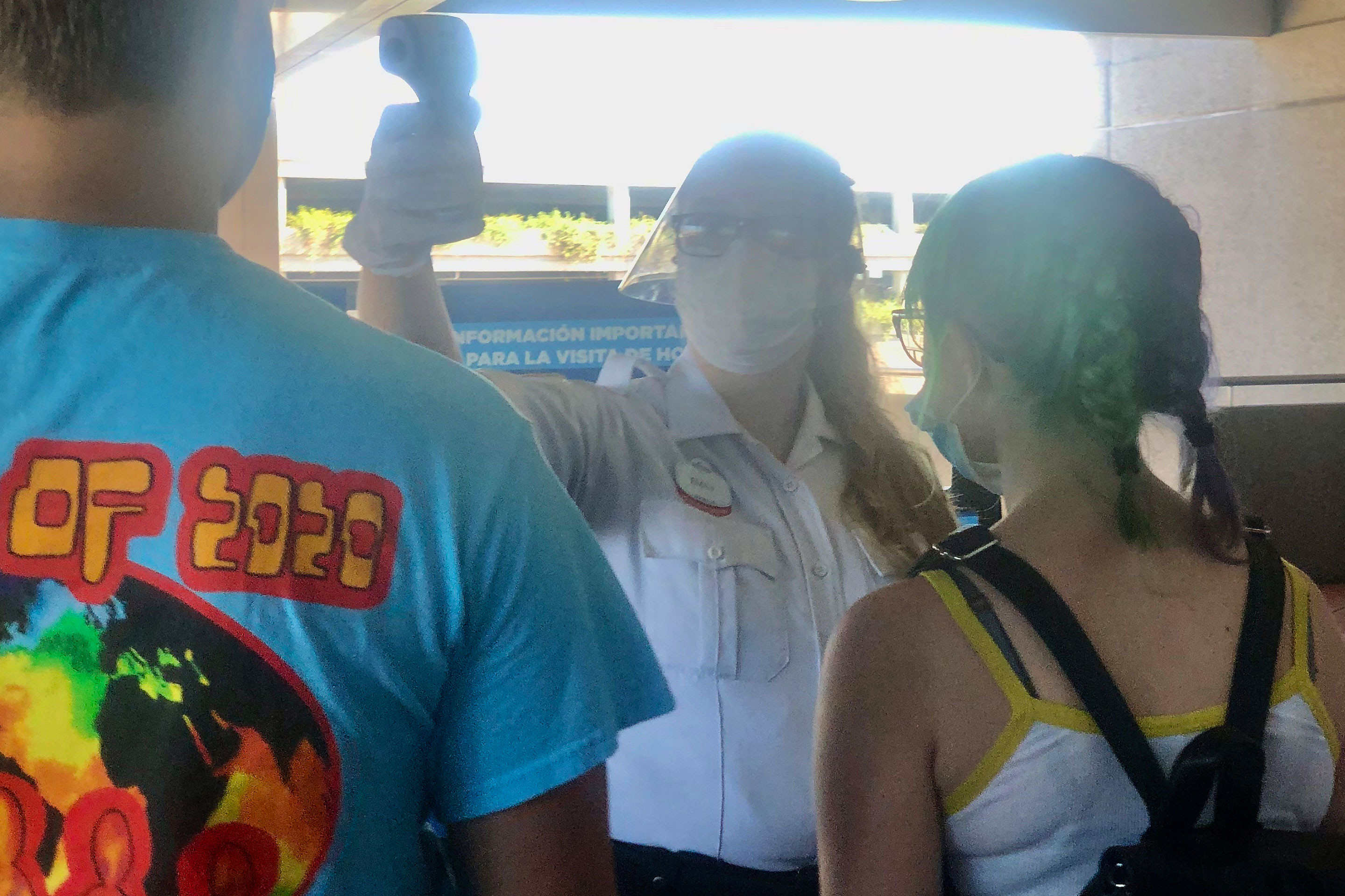 Guests receive their temperature check from a Universal Orlando Team Member prior to park entry.