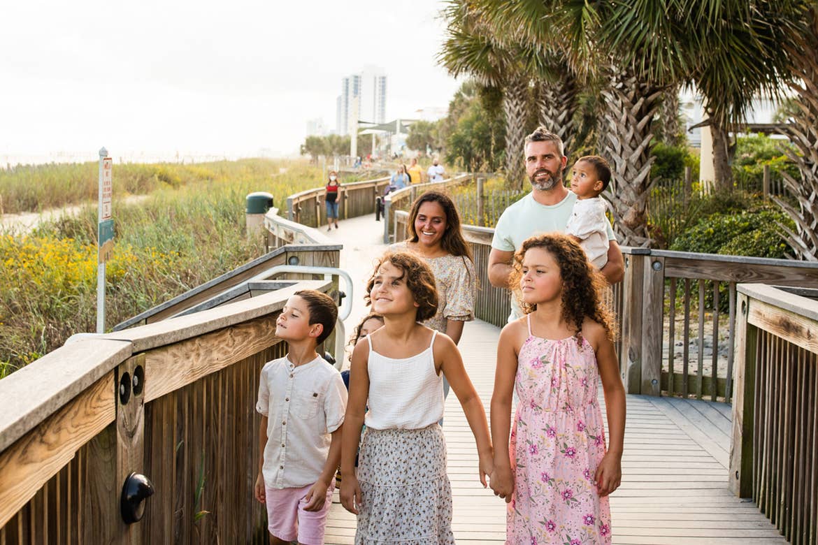 Author, Brenda Rivera Sterns' family walks along the boardwalk near our South Beach Resort in Myrtle Beach, South Carolina.