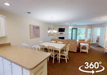 Dining area and living room in a two-bedroom Presidential villa at Fox River Resort in Sheridan, Illinois.
