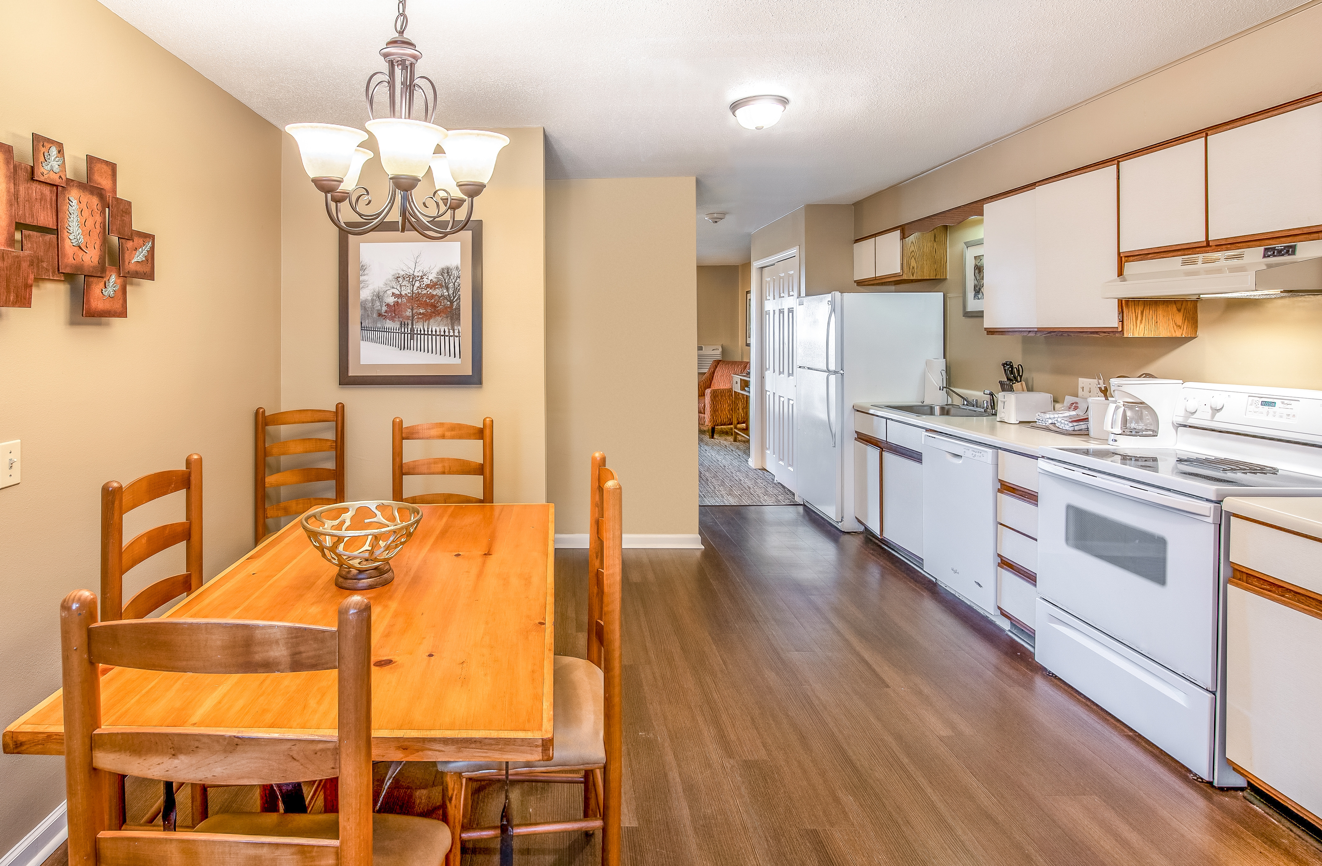 A kitchen and dining table in a one bedroom villa at Oak n' Spruce Resort in South Lee, Massachusetts