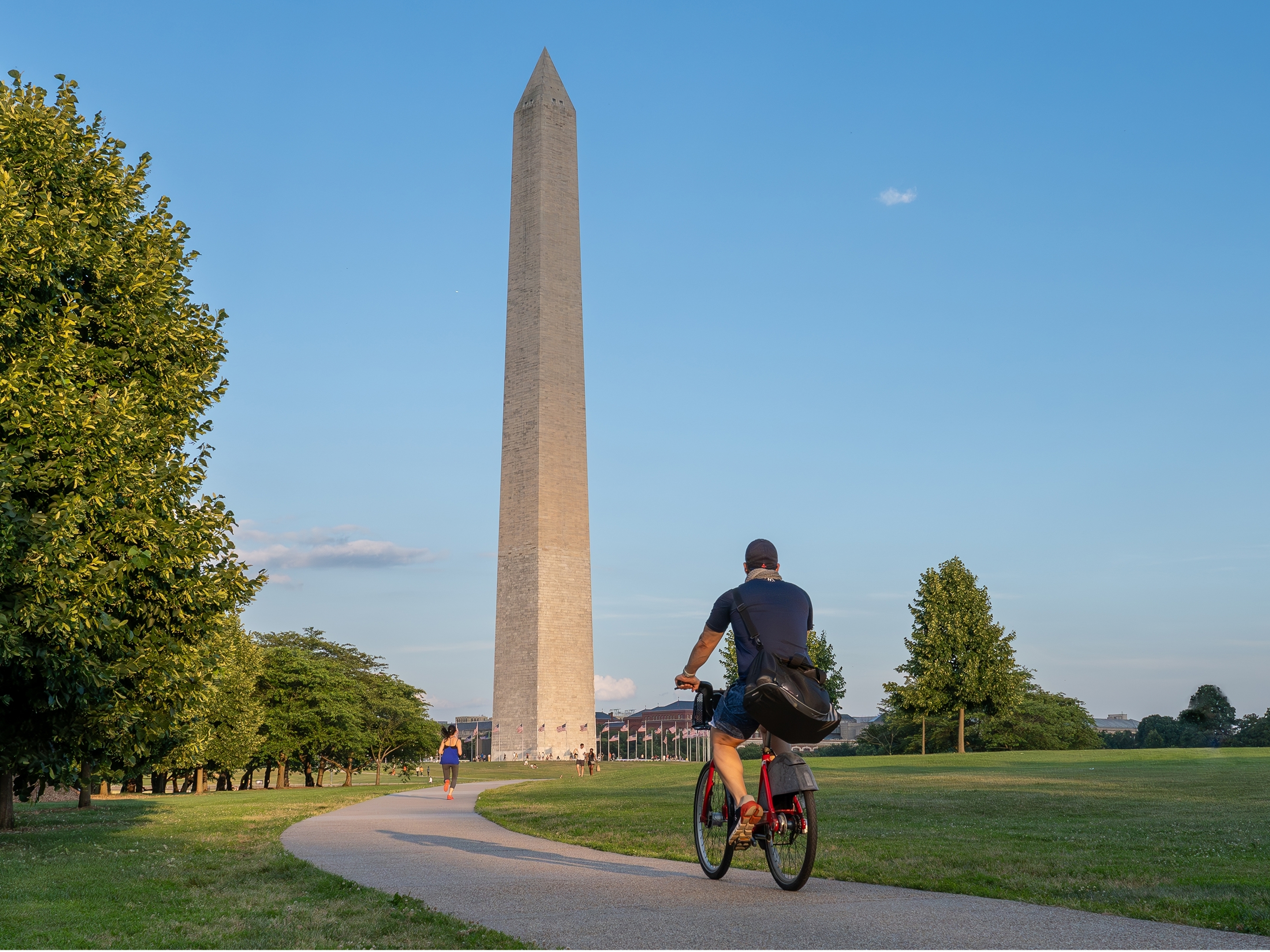 Guest riding a bicycle toward the Washington Monument in Washington, D.C. 