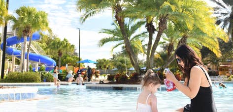 Woman and child sitting in lazy river.