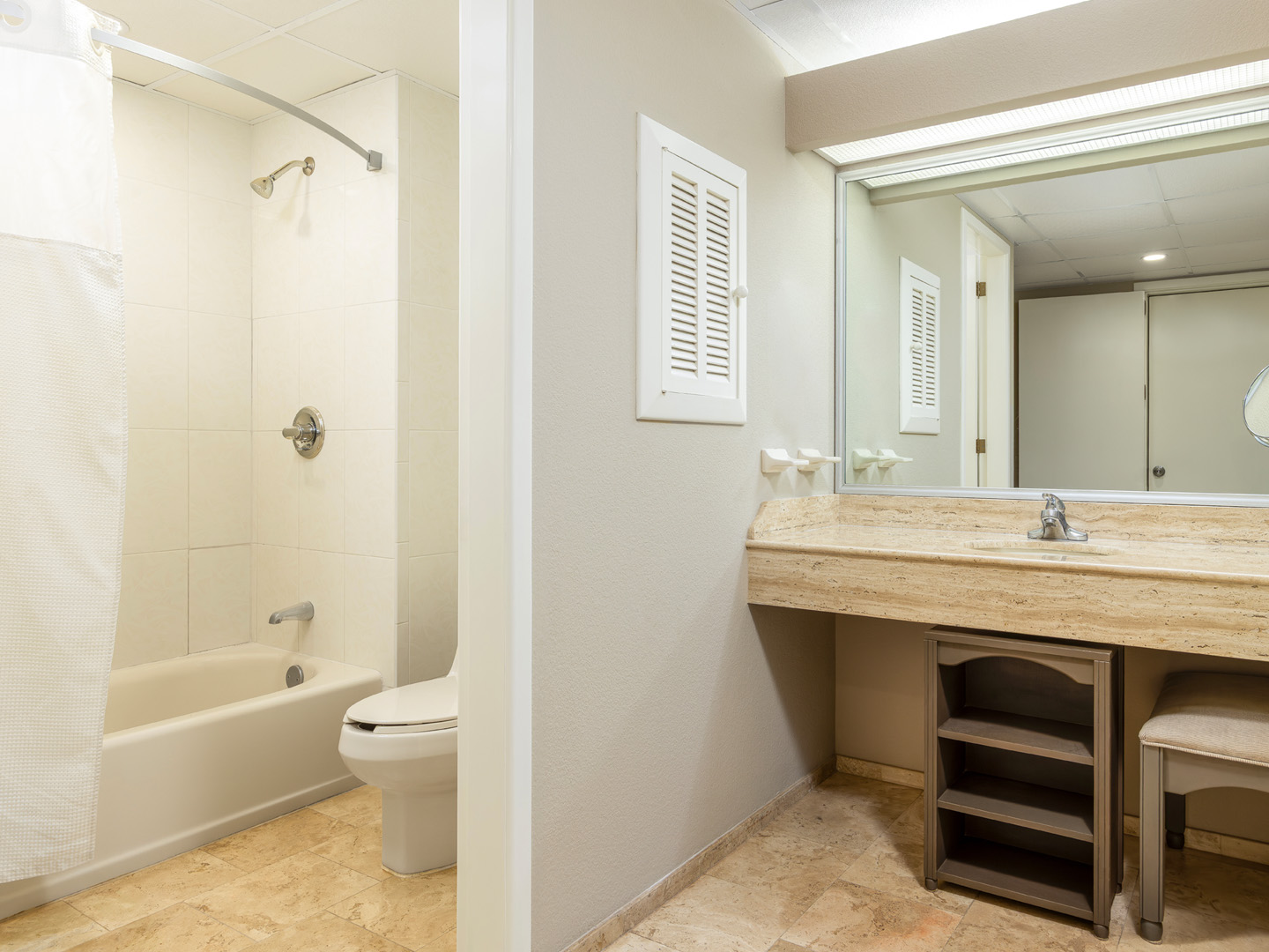 Spacious bathroom with granite vanity and tub-shower combo.