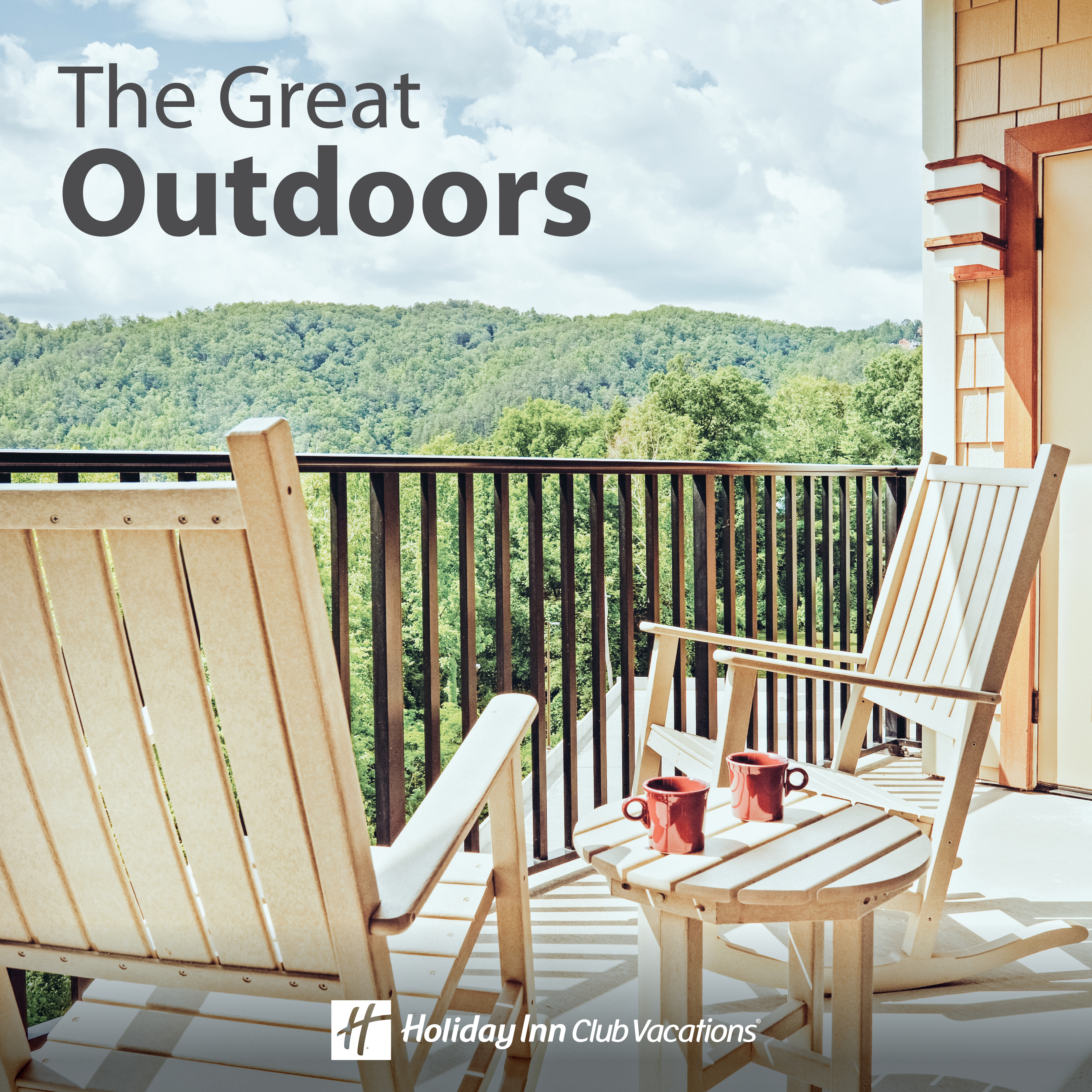 Two rocking chairs on a porch with the mountains in the background.