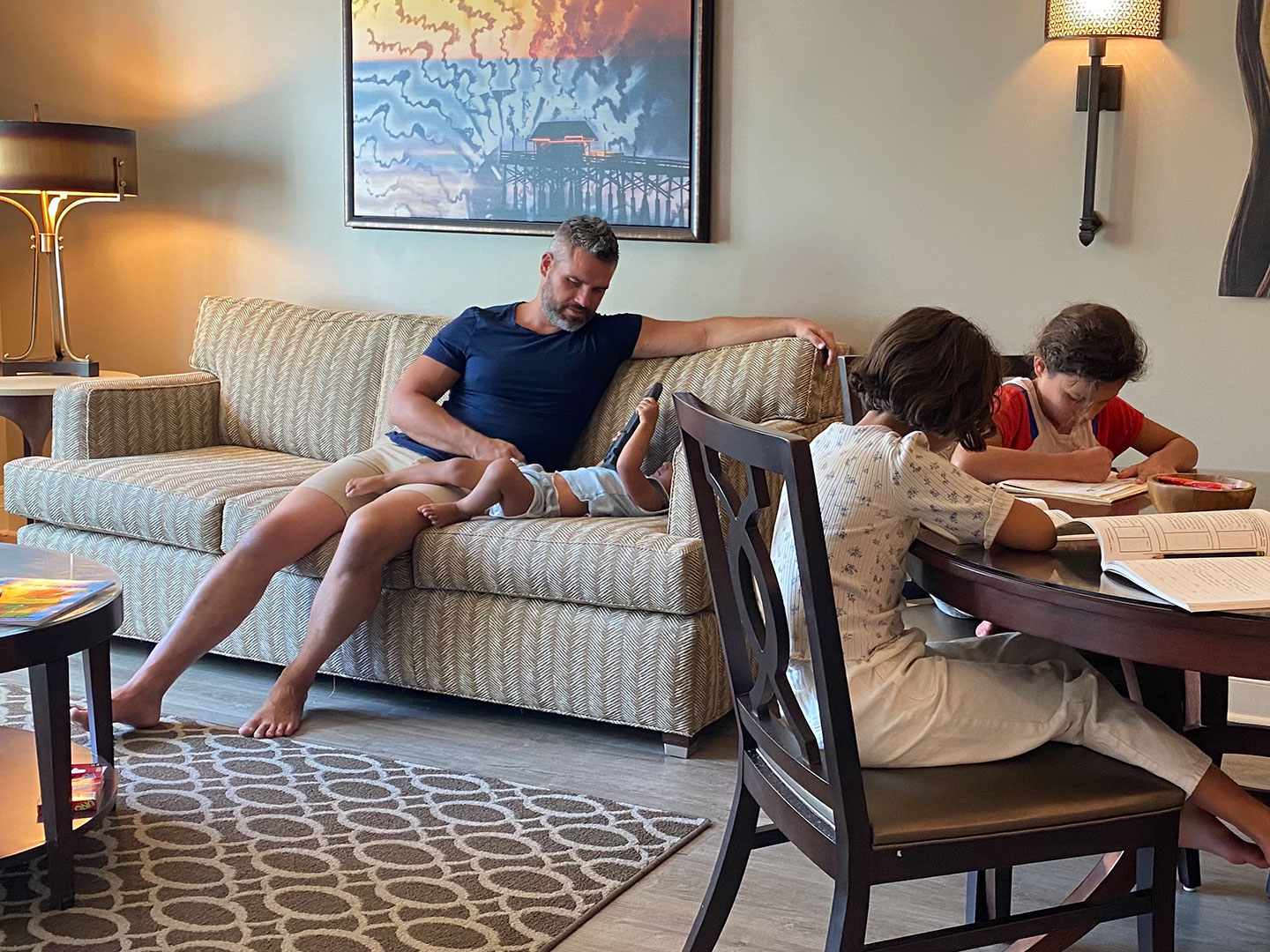 Brenda's family sits in their villa with work and play.