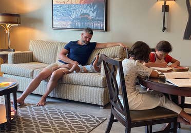 Brenda's family sits in their villa with work and play.