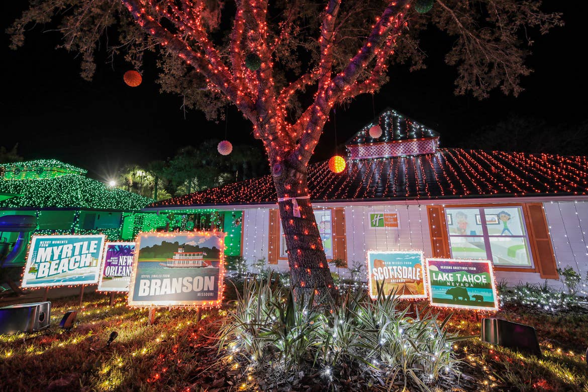 An exterior shot of our HICV villa decorated for the 'Night of a Million Lights' event complete with oversized travel postcards and a family station wagon.